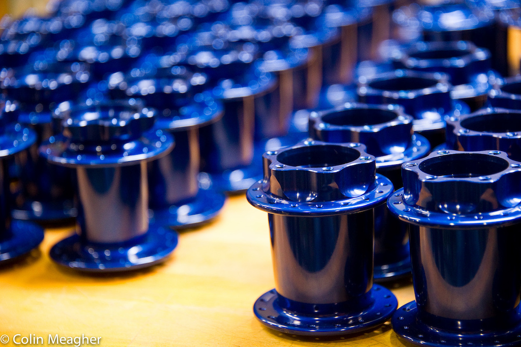 Blue jewelry freshly anodized disc hubshells in queu for laser etching. Anodizing is currently the only process that CK outsources to one of two local companies . Anodizing is not an environmentally friendly process but CK is currently working on bringing that process back in-house in order to utilize a closed process to limit environmental harm.
