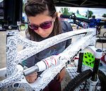 Helena Juhasz of North Shore Bike Shop works on the doodle art on her custom Transition during MEC Bike Fest in North Vancouver.