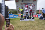 Si Paton live streaming the podiums during The Schwalbe British 4X National Championship at Moelfre Hall, Moelfre, United Kingdom. 11July,2015 Photo: Charles Robertson