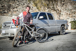 Palmer poses with the one-off Aluminum Socom in front of his new Daily Driver, a 2006 Chevrolet (Silverado) SS.  The bike is a 6" travel bike with M16 linkage.