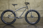 Black Sheep Bikes from Fort Collins, Colorado had this 25.6 lb. fat bike with flexing plates in the fork and chainstay yoke. They say the travel is 25-40mm.