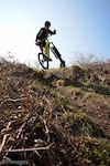 Falmouth Cycles sponsored rider Jake Marsh scrubbing of a drop on the DH track on Rosewall Hill in St.Ives.