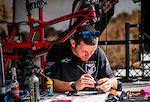 Ben Arnott going over the finer details on Angel Suarez's bike.
