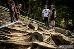 Aaron Gwin and current number 7, Neko Mullaly scope out the last few stumps and roots coming off the altered loamy 'war zone' section.