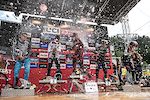The fastest men popping bottles on the podium in Val di Sole.