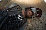 Kirt Voreis relaxes in the dirt for a minute after a crash on his mountain bike.