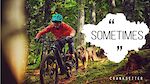 Helene riding a loam trail with her trail dog Merlin close behind her. This is the thumbnail of her latest video