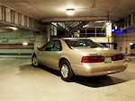 My 1997 Ford Thunderbird LX. (last year they were made in a coupe, before that fugly convertible was made). 

I got bored and went shooting my car at my old school and at my friend's work at night. :)