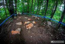World Cup downhill tracks are supposed to be rough and technical, but it seems this year the track has been soothed out just a bit more. There may be about 12 cans of orange spray paint on the rocks.