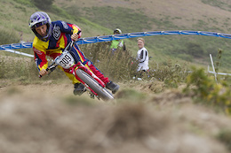 Farther Mark Fernihough watches on as Juvenile rider Harry Fernihough rails a turn during open practice of The Schwalbe British 4X National Championship at Moelfre Hall, Moelfre, United Kingdom. 11July,2015 Photo: Charles Robertson