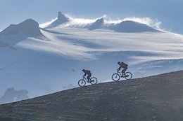 Four friends went to Iceland last summer.  We brought our mountain bikes.  On one of our first rides, we pedaled up a long dirt road to the toe of a glacier.  We were in fog almost the entire time.  Just as we started our descent, the fog cleared, and we had an incredible view of the glacier and a bit of cool air rolling over the summit. Snapped this picture while riding down the moraine.  So epic!