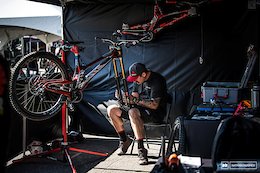 John Hall working on the bike that Aaron will almost certainly not ride this weekend, while AG's race machine hangs on the tent wall behind.