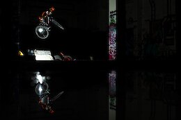 Off camera flash by rider, continuous light behind, puddle for reflection.