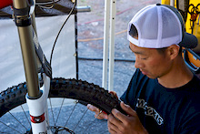 Racing is about minimizing some risks and taking others. Bassman, one of two  wrenches handling Rocky Mountain/Maxxis duties, inspects a tire for imperfections.