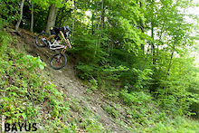 Come flying out of the woods onto the fire road below for a left hand drift-tastic turn.  Don't let the photos deceive you... a little too much pop off the top could send you right to the bottom.