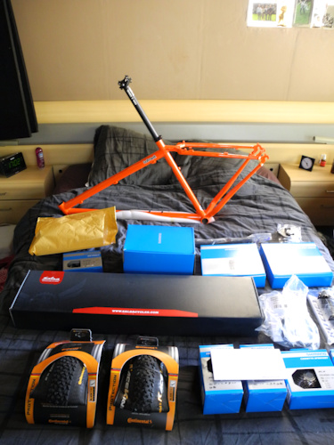 New parts for a full custom On One Inbred 29er. Cheap; SLX, MT66, Salsa steel fork, Ritchey parts... That sassy orange combined with black is really sweet. Can't wait to build it.