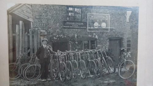 a photo taken of William Charles Taylor (my great great uncle) at his bike shop in the year 1914