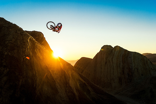 Kirt Voreis performs a table on his Niner Bikes RIP 9 RDO on a giant natural quarter pipe in the California desert.