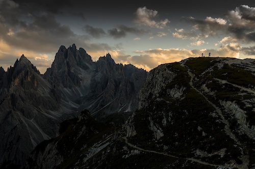 British professional endurance mountain bikers Rob Dean and Josh Ibbett on a late evening warm-down following their attempt to Mountain bike circumnavigate the challenging 90 Km Lavaredo Ultra Trail marathon running route, Dolomites, Italy.