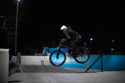 180 Bar off the bank. Riding a Chromag Monk, purple.