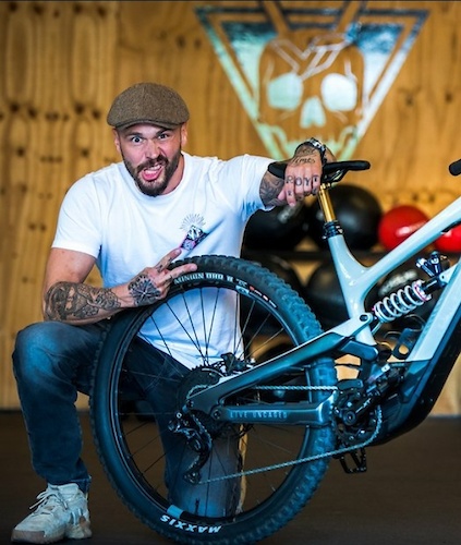German YT owner again highlighting Punisher skull with odd facial expression. Is the hand gesture indicating his bikes are not 1 