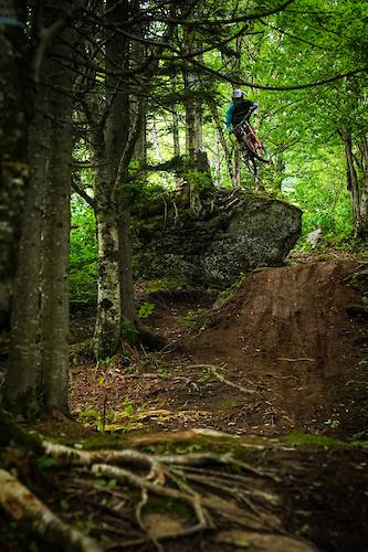 Photo credit: Mark Clement.

Elliot Demers shows the way off the "One Butter" drop at the top of Double Down trail (formerly "One Love" trail) at Bolton Valley in early summer 2020.