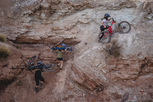 Hannah Bergemann, Michelle Parker, Vinny Armstrong hike bikes up the venue on ride day 1 at Red Bull Formation in Virgin, Utah, USA on 29 May, 2021