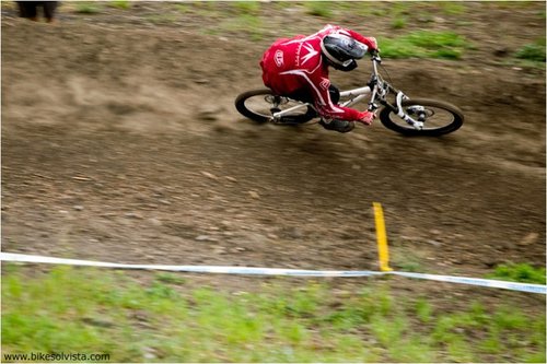 Kain Leonard rails a berm near the finish of the DH track