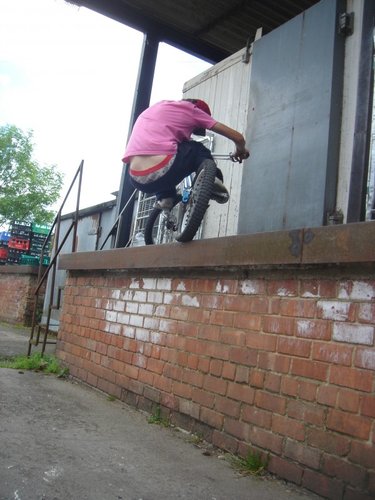 A TGS rider side hoping a large wall