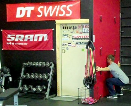 The bottom position of a wall squat, part of the 15 Minute Trail Rider Tune Up Workout.