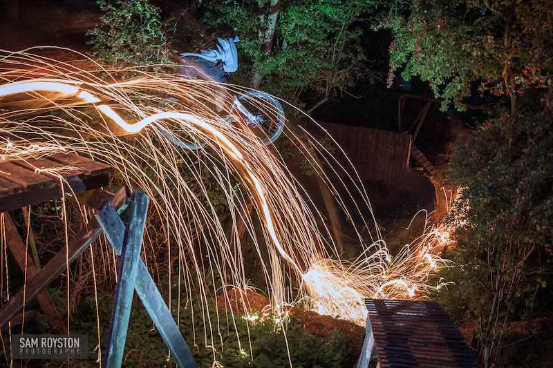 Nathan from UK Bike Skills sending mousetrap in the dark, just the sparks from his wheel helping to light the way.