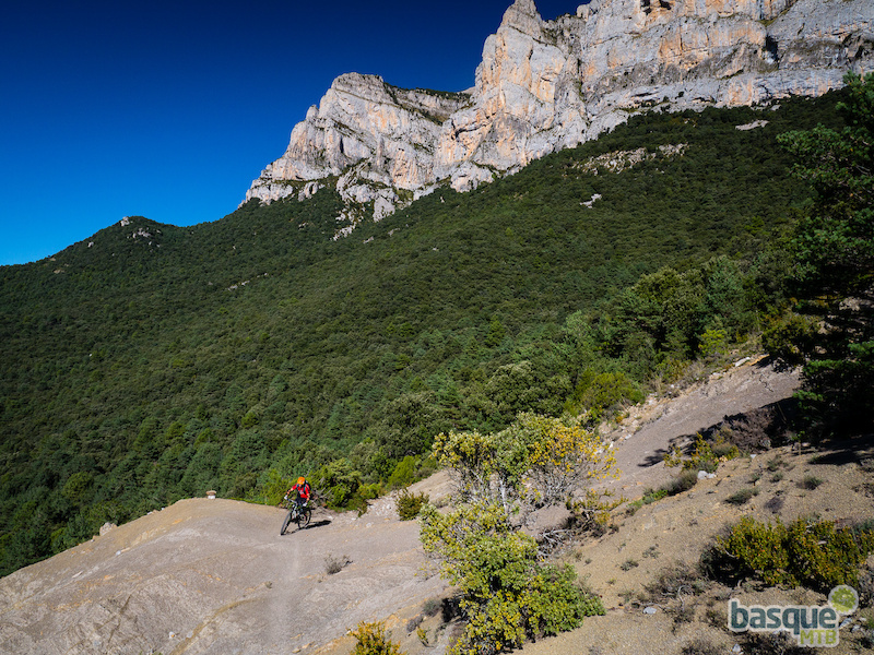 Riding out of the forest for a bit on this big mountain descent.