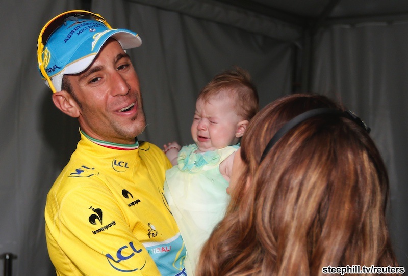Vincenzo Nibali joins an elite club: 6th rider to win all 3 Grand Tours. First Italian in 16 years
to win the Tour. Marco Pantani last won in 1998...
Astana team rider Vincenzo Nibali of Italy celebrates his overall victory with his wife Rachele and their baby after the 137.5 km final stage of the 2014 Tour de France, from Evry to Paris Champs Elysees, July 27, 2014.           REUTERS/Jean-Paul Pelissier (FRANCE  - Tags: SPORT CYCLING)   - RTR40B40