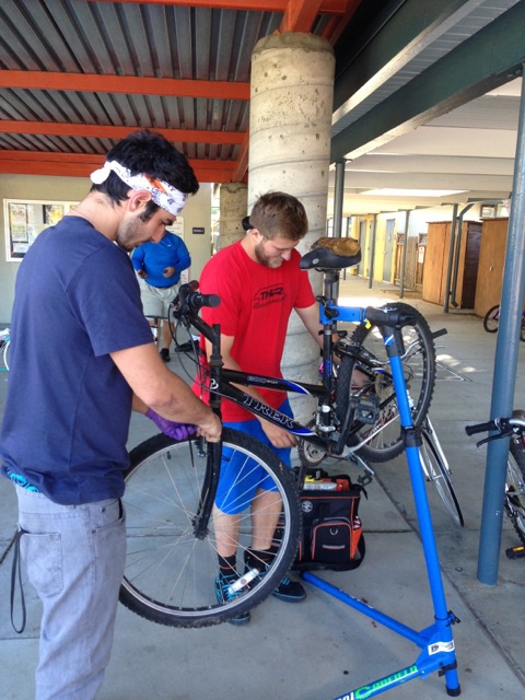 Austin Tognetti and Ashton Smith prepare a bike for a student who could not afford a bike and needed a way to get to school.