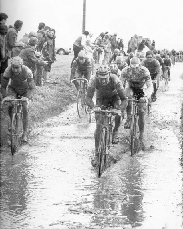 Also memorable was the weather; just plain wet turning the narrow roads muddy and slick. Sean Kelly famously said, "A Paris-Roubaix without rain is not a true Paris-Roubaix. Throw in a little snow as well, it's not serious."

We associate Paris-Roubaix with the rain, the additional difficulty created by the rain that draws us to it.   

Appropriately called... L'Enfer du Nord.
