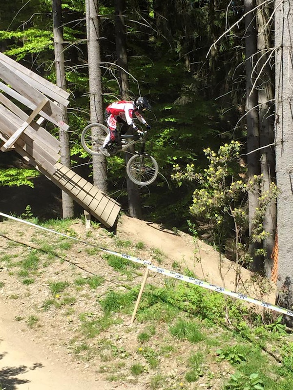 Jumping of the wooden bridge from other angle on the DH track.