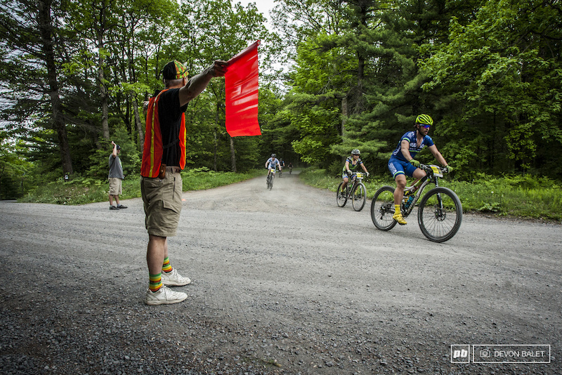 Riders finishing up a long road section before entering Tower Trail and the second enduro segment.
