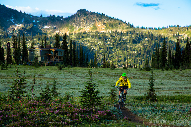 A mountain biker enjoys pristine alpine singletrack right out the door of the lodge at Sol Mountain Lodge in the Monashee mountains near Revelstoke British Columbia.