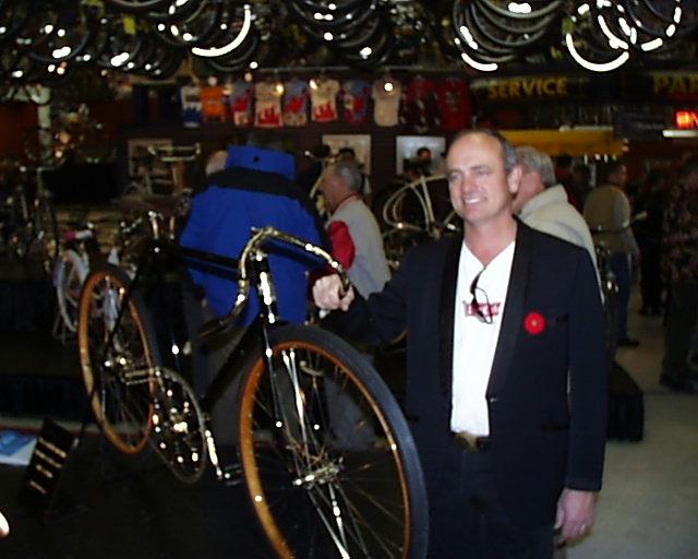 Bow Cycle's owner, Brian Sibthorpe in front of one of his beautifuly restored bikes at the "Bow Cycle's Classic Collection" - antique bike show on November 11, 2000.  