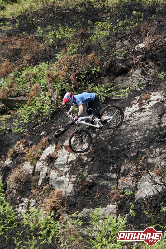 riding down the steep burnt rock faces