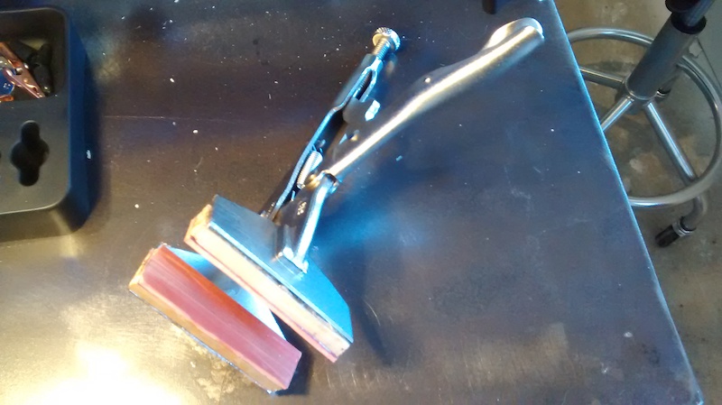 Maybe there s already a commercially available tool just like this and I m late to the party as usual but this thing is worth it s weight in gold for building wheels with round straight pull spokes. Basically a welding clamp with wood blocks to make the jaws meet parallel and rubber gasket material to grip the spokes so they don t spin as you tighten the nipples. Speeds up the build by quite a bit and leaves my fingers feeling good enough at the end of the day to grip other things... 