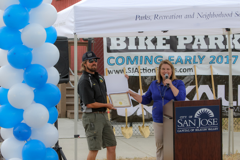 Vice Mayor Rose Herrera hands an award of accommodation to Trail Head Cyclery Owner Lars Thomsen. Trail Head Cyclery is a local bike shop about 20 minutes from the location of the park. When asked how he felt the park would impact the shop Lars said It will be great for us. We will add a rental fleet of DJ bikes and will stock parts and accessories for that rider group . He mentioned other locations such as Calabasas a place where local Ryan Nyquist grew up. Calabasas was a good place Thomsen said but it had a rougher crowd and was a place that wasn t closely monitored where as Cunningham is a city ran venue with supervision and it s super family friendly .