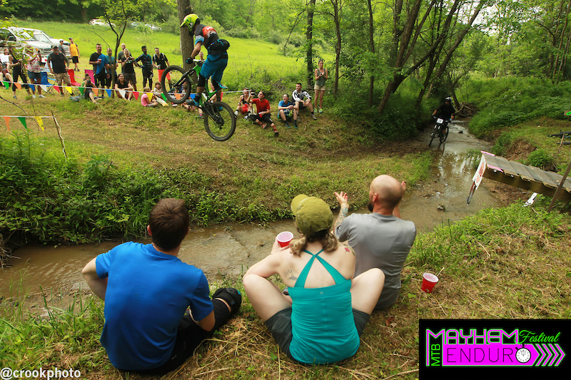 One rider clears the creek gap at the end of the final stage of the 2016 Mayhem Enduro in Cumberland Ohio on May 29. Another rider can be seen riding the go-around through the creek.