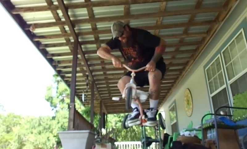jumping an old tricycle on my porch...