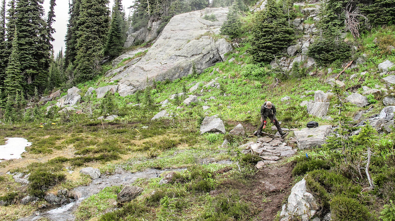 It s a labour intensive process building trails in the alpine but the effort is needed to build sustainable trails. Marc Reimer laying rocks on the South Caribou Pass trail.