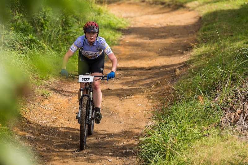 Annalise Gillespie heads for the feed zone at the Professionals Rotorua National Schools MTB Championships Presented by Altherm Window Systems. Credit: Fraser Britton / Crankworx