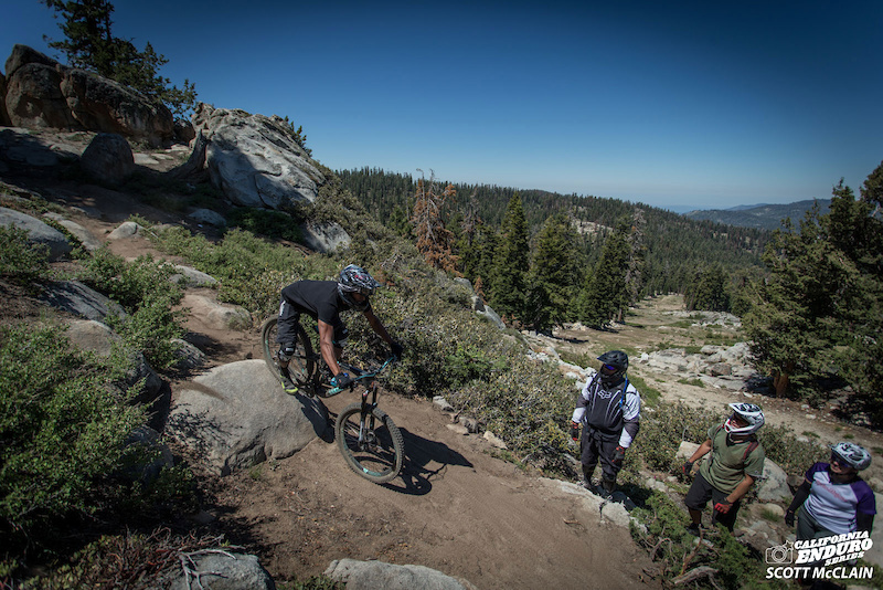 Brian Astell TrailWorks showing his skills class how to successfully navigate Stage 3 s rocky sections on practice day.