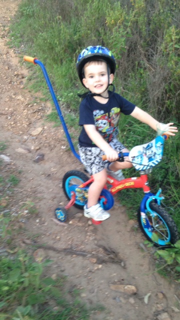 So we head off from our yard for a path ride . Matthew says " mountain bike " and points to fire trails at our place . So up we go and he had his first ride on dirt yelling " wow mountain bike " . So funny seeing him trying to pedal over rocks .