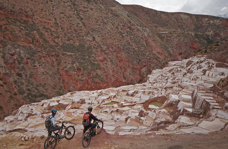Holy Trails uses this route as a more chill day of riding and an opportunity to see more Inka History and partake in local culture. The town of Maras allows access to two archaeological Inka sites – the Moray Inka Ruins and the Maras Salt Ponds. We drive through Maras and were dropped off at 3800m at Misminay.

From there we ride through villages to view the Moray Terraces. These were built by the Inka and are thought to be research terraces where the Inka would plant different crops at different elevations and aspects to see how they would grow. This South side of the valley is considered drier then the North side which has the more glaciated peaks. It is perhaps this geological aspect that also helped to create the next archaeological site we passed through, the Maras salt mines.
