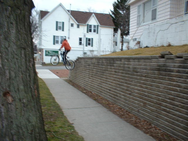 Joe dropping a retaining wall about 6 ft to flat ( St. Catharines Trials & Freeride Crew - http://sctfc.cjb.net )